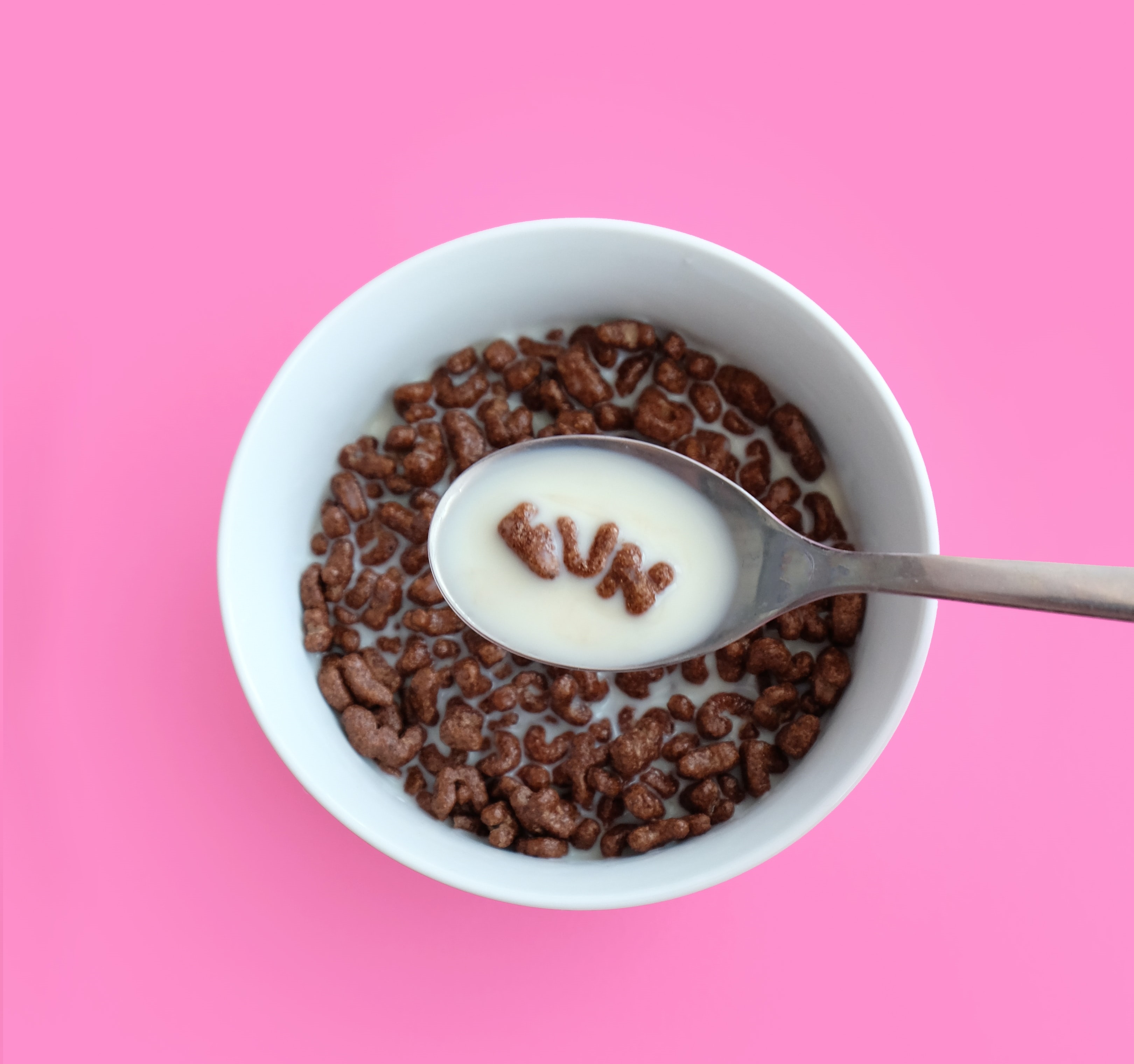a bowl of cereal on pink background