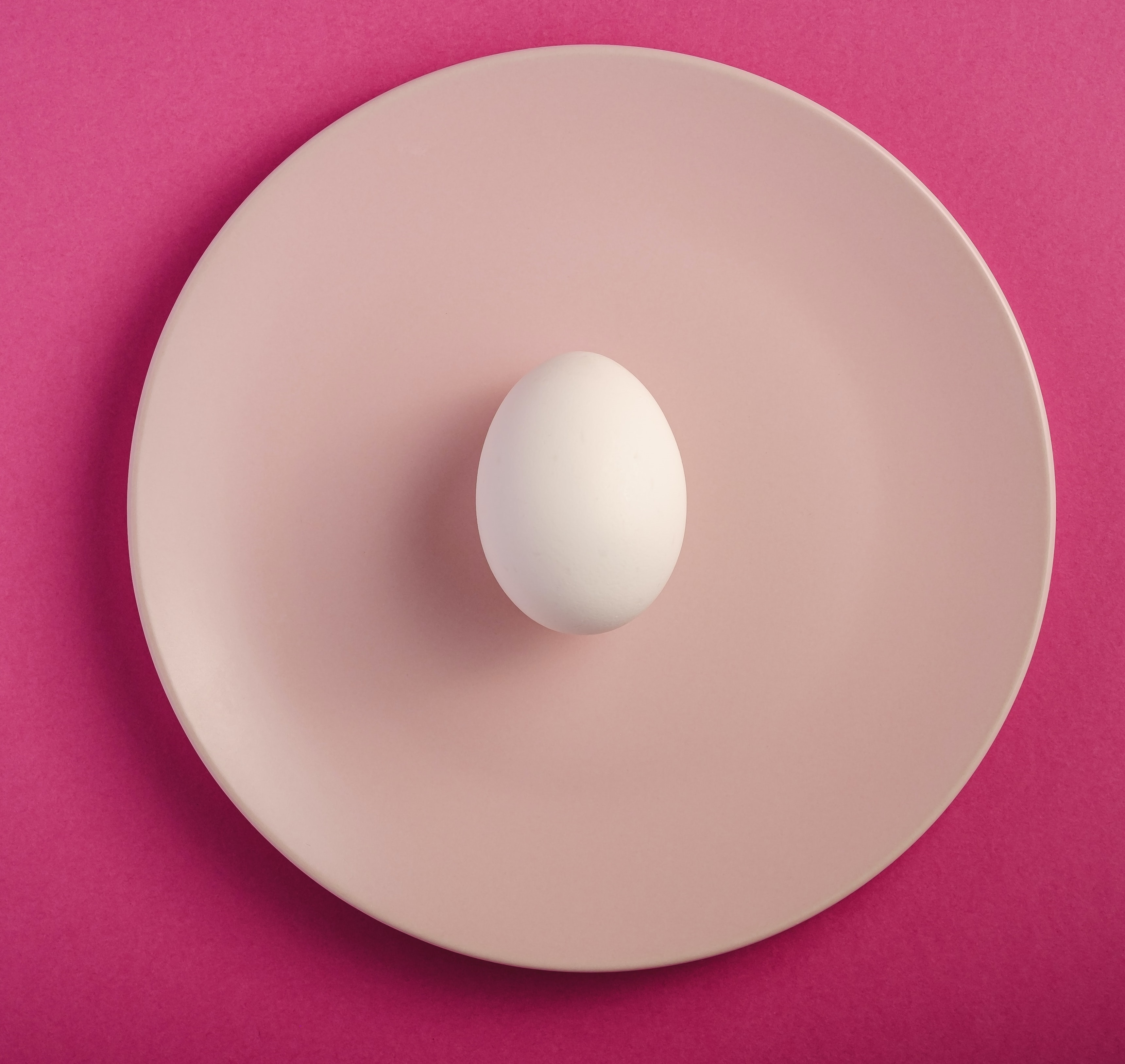 an egg on pink plate